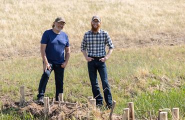 Markus Erk and his son, Colton, stand next to a beaver analog.