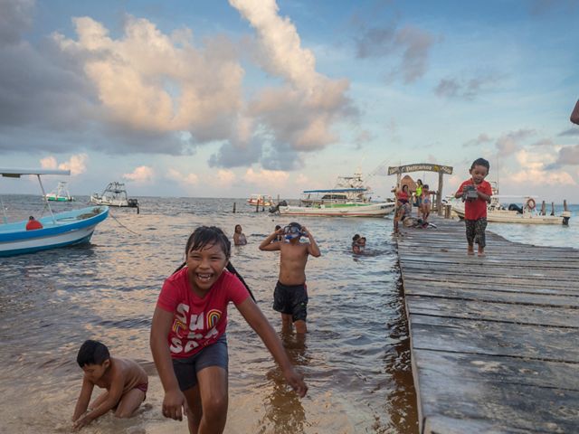 Children play on the shore near the Puerto Morelos pier.