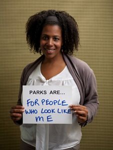 Rue Mapp portrait. She holds a sign saying 'Parks are for people who look like me.'