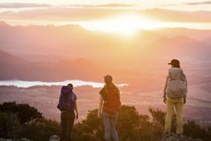 Three people look at a scenic Australian canyon.