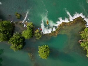 Kayakers Filip Ferderber (in white and blue kayak) and Luka Dzajo (orange and red kayak) and Luka Seketa kayaking down a small waterfall in Mreznica river near Keici in Croatia.Filming crew with Ciril Jazbec, Ausma Cirulniece, Matic Oblak and the local kayaking guide Kreso Rogoz are in yellow boats next to them.Kreso Rogoz is “Croatia Open Land tours DMC” business owner who is passionate about sustainable tourism, travel and leisure industries, as well as certified guide to cultural heritage in the EU.Luka Seketa is a local kayaker working in “Croatia Open Land tours DMC” as a kayaking guide for tours on the river.