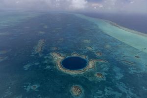 The Great Blue Hole is a circle of deep blue off the coast of Belize.
