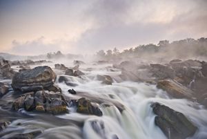 White waters rush over large boulders.