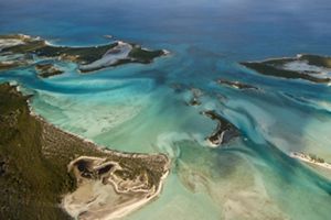 Aerial view of several small islands in tropical waters.