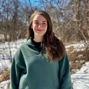 Person in front of snowy nature smiling