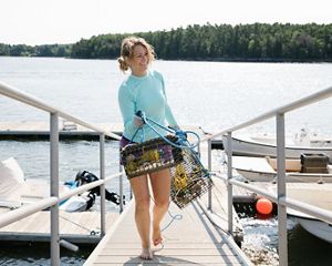 Amanda Moeser gathers oyster cages and inspects them for spat.