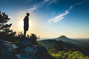 Man watching a sunset at Rattlesnake Ridge Natural Area.
