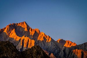 A mountain lit up by sunshine.