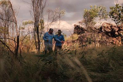 two fire rangers in a dry landscape.