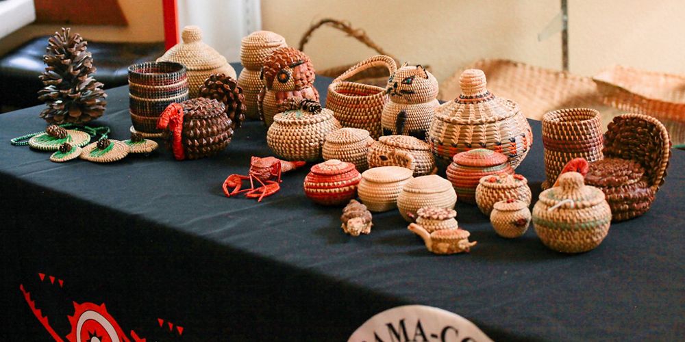 A table filled with woven baskets and animals.