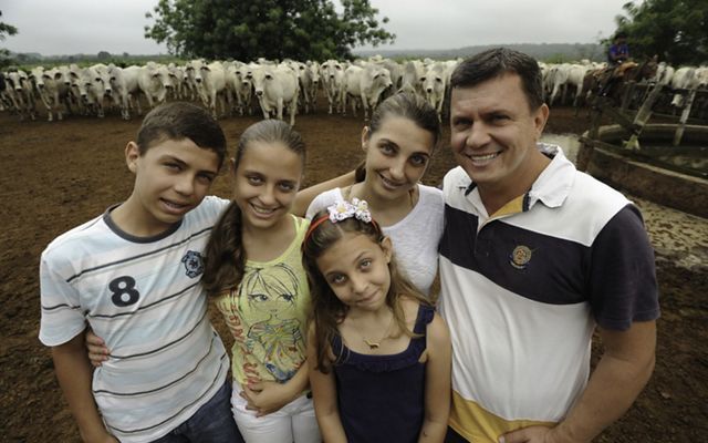 Family photo in front of cows.