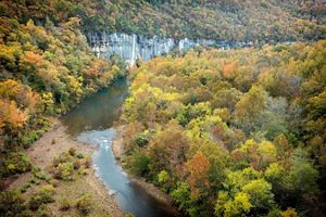 The Buffalo National River flows past rock bluffs.