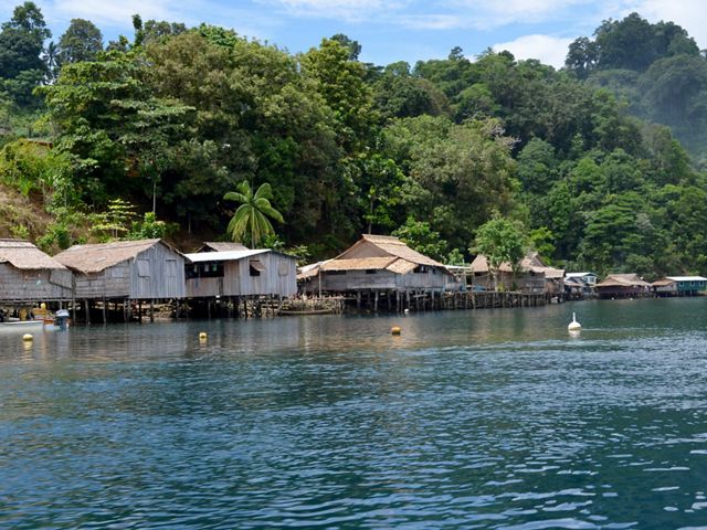 Wooden houses on stilts in the water.