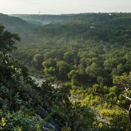 Cibolo Creek gently flows between the rolling, green vistas of the Texas Hill Country, dotted by cactus and shrubs.