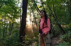 TNC volunteer Cindy Leffelman hikes through the forest at Green's Bluff nature preserve.