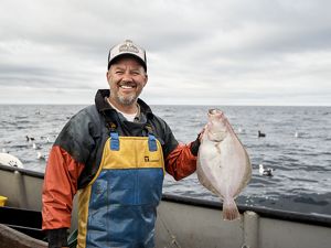 Steve Fitz holding a Petrale sole aboard the Mr Morgan based out of Half Moon Bay.