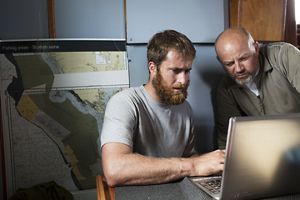 Steve Fitz a member of the CGC looks over a recently updated fishing plan with his crew.