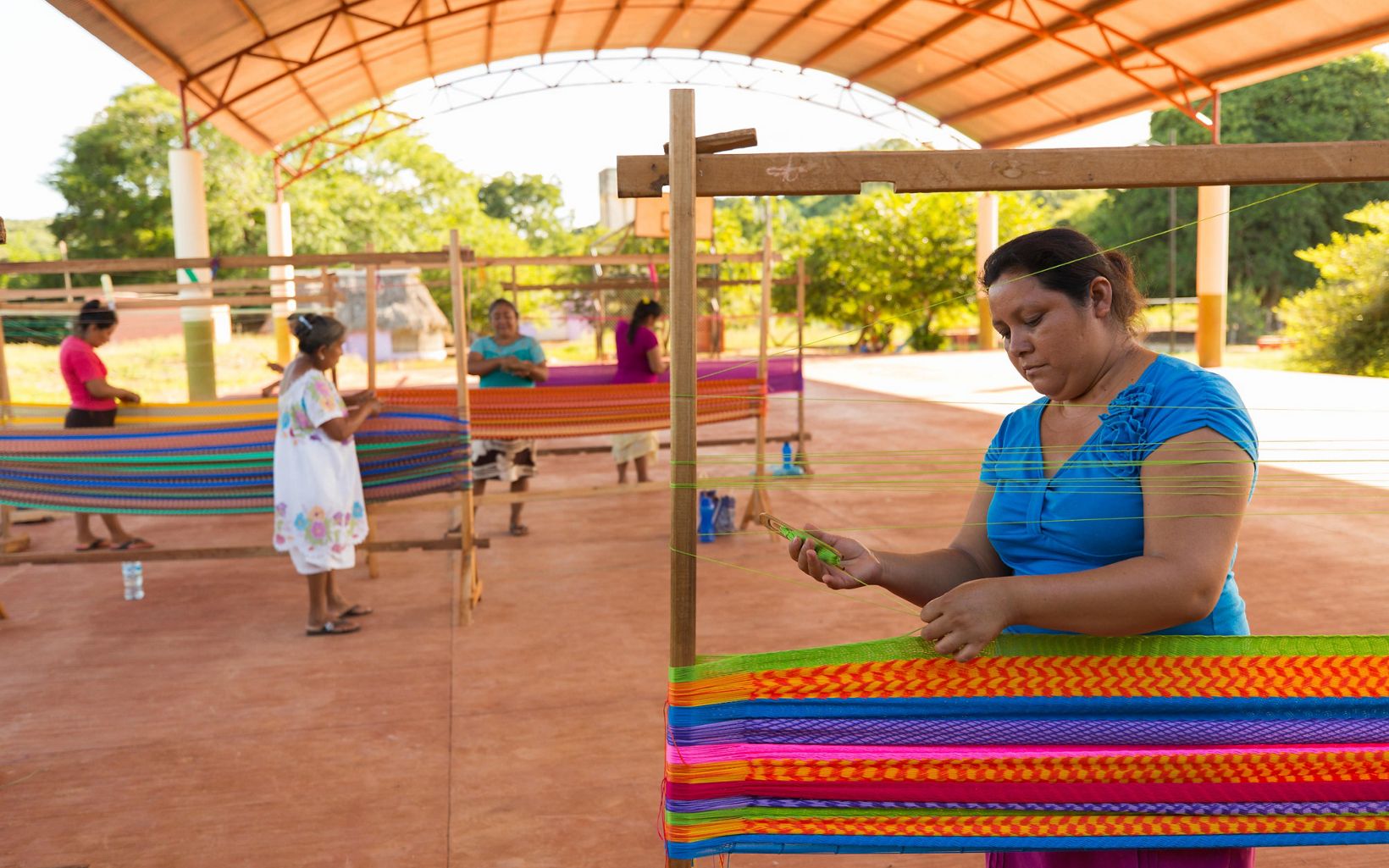 Women's cooperative of hammock Women from the San Agustin ejido cooperative weaving traditional Mayan hammocks to sell in Merida near San Agustin, Yucatan, Mexico.  © Erich Schlegel