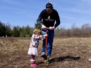 MD/DC Director of Marketing Sev Smith gets a helping hand from daughter Charleigh during red spruce planting at Cranesville Swamp Preserve.