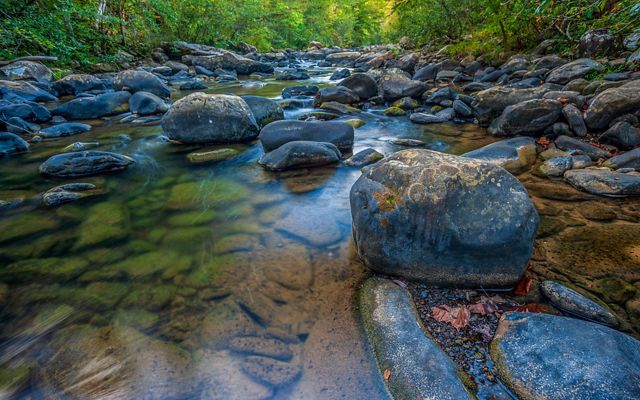 Tackett Creek, a stream with large stones and reflections, located on the Ataya Tract of the Cumberland Forest Project in Tennessee