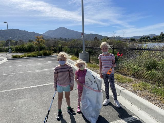 Charlotte Davis with her family and friends cleaning up trash.