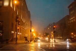 A photograph features the streets of Washington, DC during a heavy rainstorm.