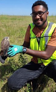 Photo of Derrick Mason holding a hawk.