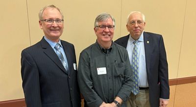 Ken Kunkel, Jim Angel, and Don Wuebbles pose for a photo.