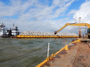 A barge full of limestone boulders to be used for oyster reef construction at Galveston Bay.
