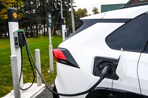 A car white card is plugged into an electric charger. 