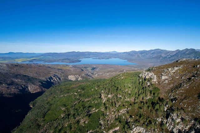 An aerial view features South Africa’s mountains and forests.