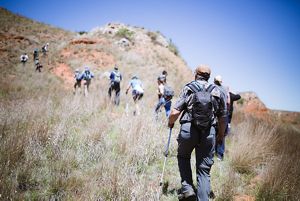 A group of hikers climb up a hill in the Oklahoma Canyons.