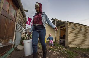 Perched on a hill overlooking the vast Atlantic Ocean, Redhill is an informal settlement of about 1000 residents living in small makeshift homes. Thobeka (17 years old), her mama and 1-year-old sister live here in a one bedroom home with no running water. The family fetches water from a communal water tap for daily use (cooking, brushing teeth etc). Due to the severe water crisis at the time, this community tap would be waterless a few times a week. During those times, Thobeka would have to walk down to the bottom of the hill to bring water in a bucket (about a 1- hour process). As a family they would use 1 bucket of water 
(approximately 20 liters) per day for cooking and drinking. 
Above: Thobeka going to fetch water (her sister in the background).