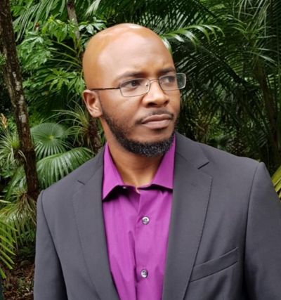 a handsome black man looking away in profile