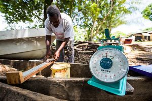 Man measures a fish on ruler