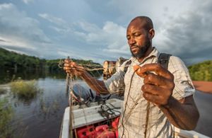 Man inspects fishing net 