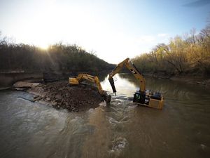 Heavy machinery works to remove the old dam on the Green River in Kentucky.