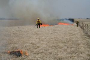A prescribed prairie fire in the distance.