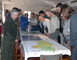 People gather around a map.