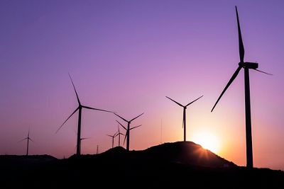 The sun rises on a wind farm in China.