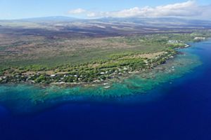 Aerial view of the Puakō, Hawai‘i coastline showing the coral reef that spans the length of the entire coast.