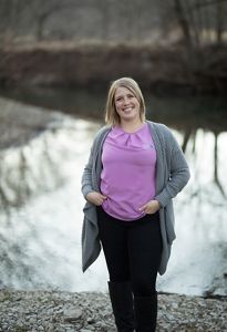 Portrait of Heidi Mehl standing outside in front of a river.