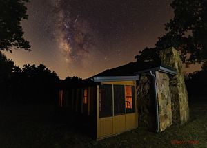 The cabin of John Joseph Mathews frames the Pawhuska night sky. 