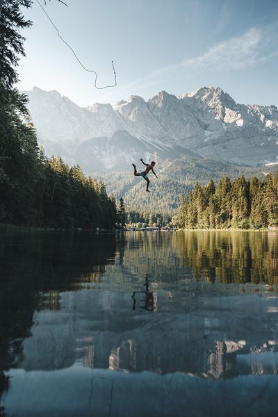 A jump into the iconic lake Eibsee in southern Germany on a hot summer day.