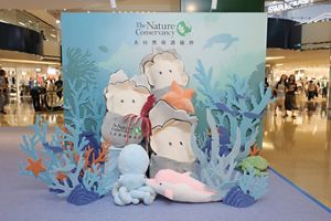 a vibrant photo corner featuring giant plush baby oysters and a cast of colorful underwater characters