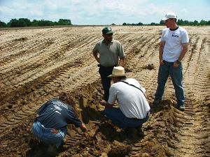 A group of staff members in an agriculture field.