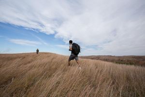 Hikers walking along a ridge at the Four Canyon Preserve.