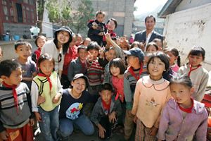 A large group of children smile for the camera.