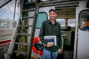 Photo of commercial fisherman Kurt Martin on his boat docked in Massachusetts.