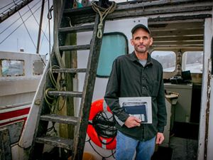 Photo of commercial fisherman Kurt Martin on his boat docked in Massachusetts.